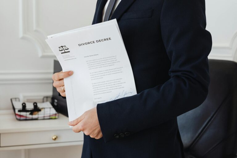 A person holding a divorce decree in an office setting, symbolizing legal proceedings.